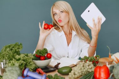 Vlogger promoting healthy eating with fresh vegetables on the table.